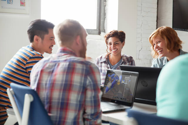 Group of creative professionals working on a HP 15 ZBook G2 and HP 17 ZBook G2 Mobile Workstation while collaborating.
